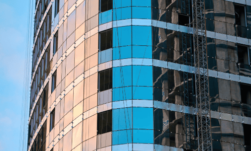 Installation of curtain wall system on a residential building with glazing panels and aluminium frame.